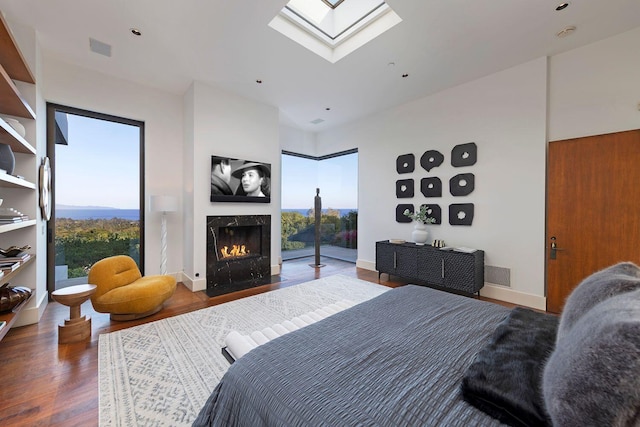 356 Woodley Rd, Montecito, CA 93108 - bedroom featuring a skylight, wood finished floors, and a fireplace with flush hearth