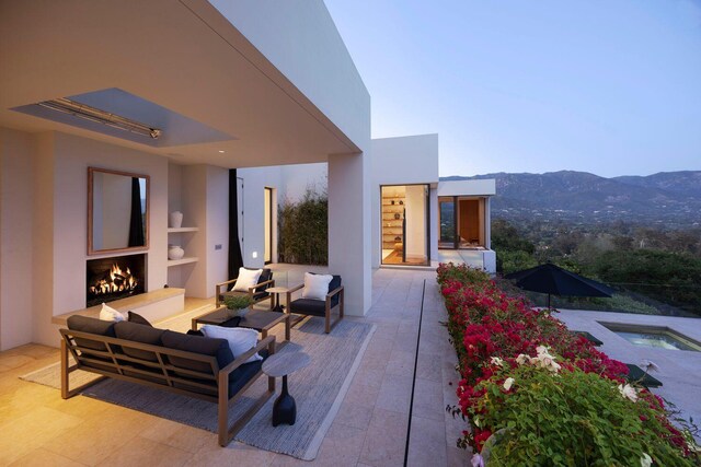 356 Woodley Rd, Montecito, CA 93108 - view of patio / terrace with an outdoor living space with a fireplace, a mountain view, and an in-ground hot tub