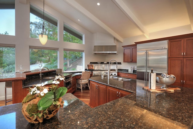 62 Canon View Rd, Montecito, CA 93108 - kitchen featuring a sink, built in refrigerator, dark stone counters, wall chimney exhaust hood, and beamed ceiling