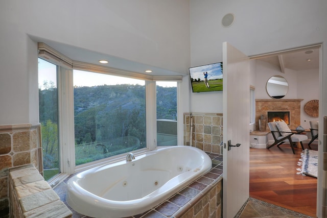 62 Canon View Rd, Montecito, CA 93108 - bathroom featuring a lit fireplace, a jetted tub, and beamed ceiling
