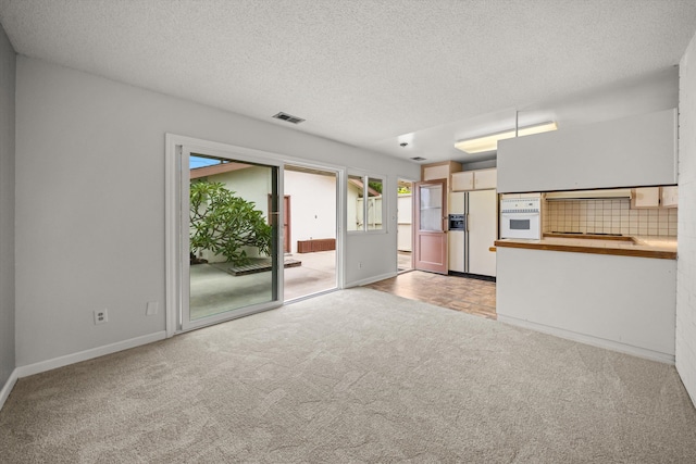 4634 Puente Plz, Santa Barbara, CA 93110 - unfurnished living room featuring light colored carpet and a textured ceiling