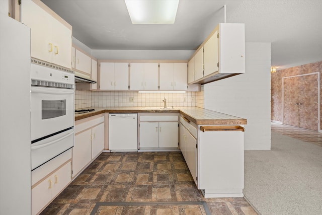 4634 Puente Plz, Santa Barbara, CA 93110 - kitchen with white appliances, a warming drawer, tasteful backsplash, light countertops, and dark stone finish floors