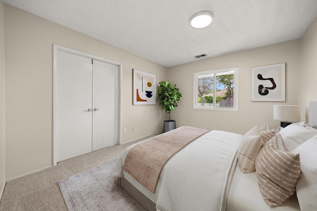4634 Puente Plz, Santa Barbara, CA 93110 - carpeted bedroom featuring a textured ceiling and a closet