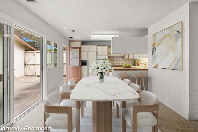 4634 Puente Plz, Santa Barbara, CA 93110 - dining area featuring light carpet and a textured ceiling