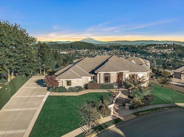 11719 SE Solomon Ct, Happy Valley, OR 97086 - view of front of home featuring a front lawn, stone siding, a mountain view, and a tiled roof