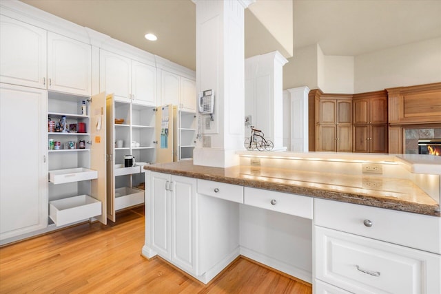 11719 SE Solomon Ct, Happy Valley, OR 97086 - kitchen featuring light wood-style flooring, white cabinetry, dark stone counters, and recessed lighting