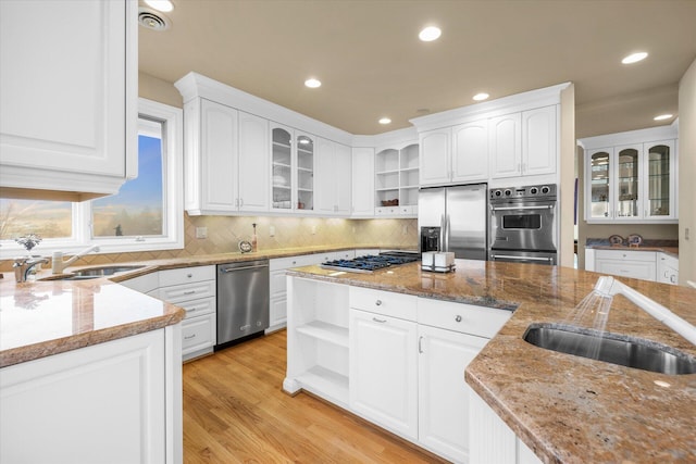 11719 SE Solomon Ct, Happy Valley, OR 97086 - kitchen with open shelves, appliances with stainless steel finishes, a sink, light stone counters, and white cabinets