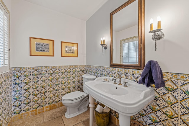 4451 Via Alegre, Santa Barbara, CA 93110 - bathroom with plenty of natural light, toilet, wainscoting, and tile walls