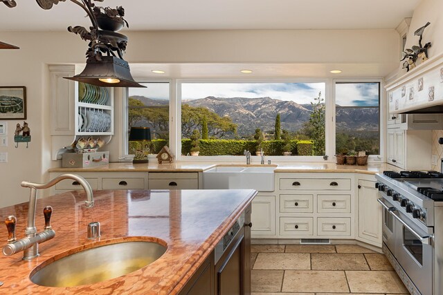 4451 Via Alegre, Santa Barbara, CA 93110 - kitchen featuring a sink, range with two ovens, a mountain view, and healthy amount of natural light