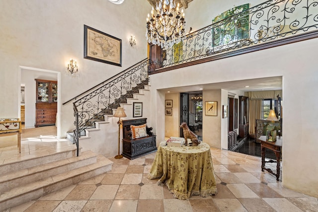4451 Via Alegre, Santa Barbara, CA 93110 - foyer with a towering ceiling, stairs, a chandelier, and stone tile flooring