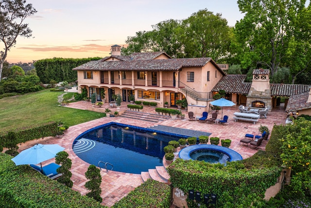 4451 Via Alegre, Santa Barbara, CA 93110 - view of pool featuring a warm lit fireplace, a patio, a yard, and a pool with connected hot tub