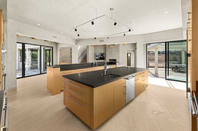 892 Toro Canyon Rd, Montecito, CA 93108 - kitchen featuring a large island with sink, dark countertops, light brown cabinets, modern cabinets, and open floor plan