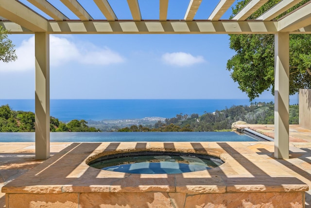 892 Toro Canyon Rd, Montecito, CA 93108 - view of swimming pool with an in-ground hot tub, a water view, and a pergola