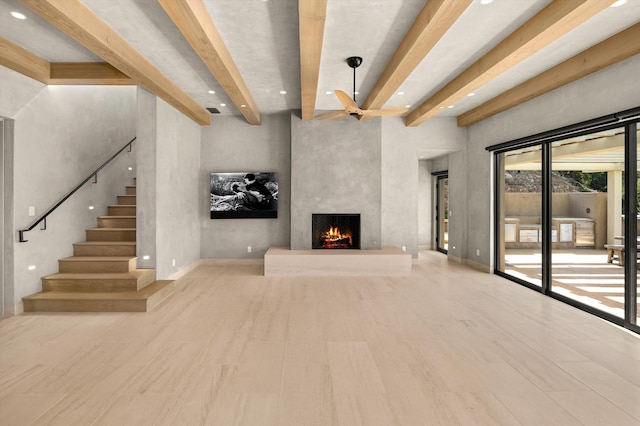 892 Toro Canyon Rd, Montecito, CA 93108 - unfurnished living room with beam ceiling, a fireplace, a ceiling fan, recessed lighting, and stairs