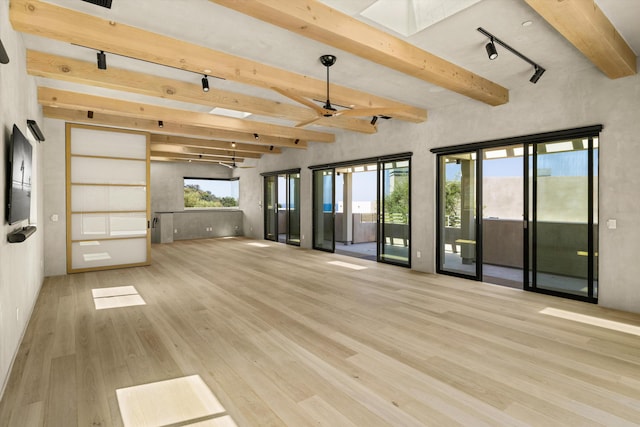 892 Toro Canyon Rd, Montecito, CA 93108 - unfurnished living room with a skylight, wood finished floors, beamed ceiling, and a ceiling fan
