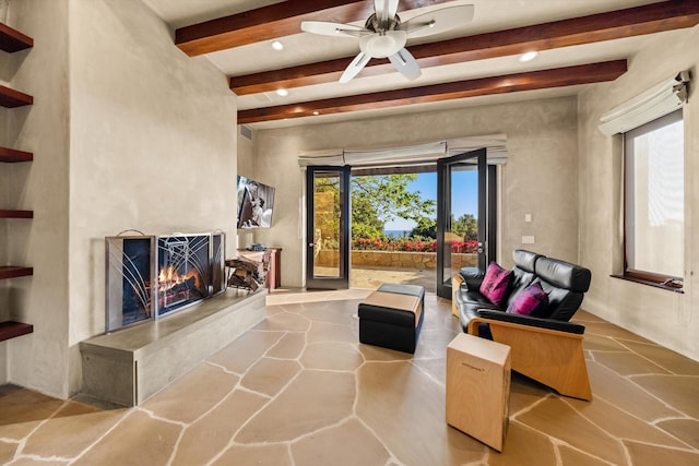 892 Toro Canyon Rd, Montecito, CA 93108 - living area featuring beam ceiling, a large fireplace, ceiling fan, stone finish flooring, and recessed lighting