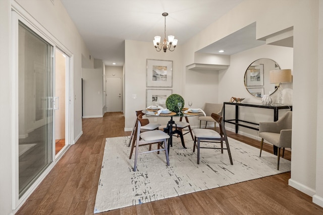 7134 Phelps Rd, Goleta, CA 93117 - dining room with wood finished floors, a chandelier, baseboards, and recessed lighting
