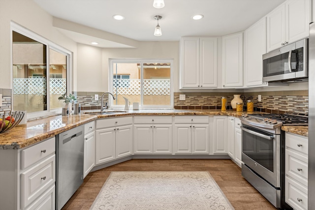 7134 Phelps Rd, Goleta, CA 93117 - kitchen with stainless steel appliances, a sink, backsplash, white cabinetry, and recessed lighting