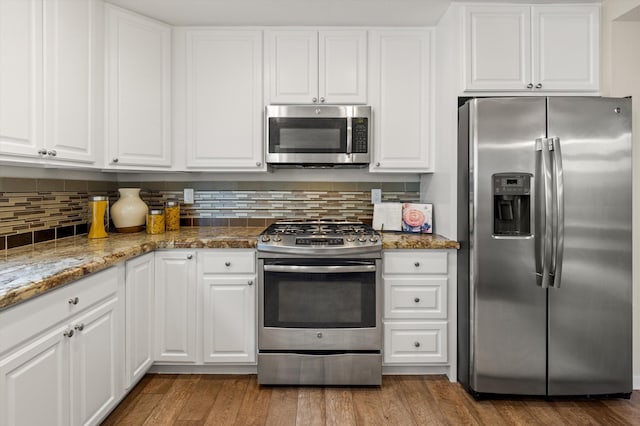 7134 Phelps Rd, Goleta, CA 93117 - kitchen featuring stainless steel appliances, white cabinets, and tasteful backsplash