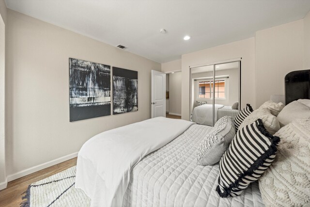 7134 Phelps Rd, Goleta, CA 93117 - bedroom featuring baseboards, wood finished floors, a closet, and recessed lighting