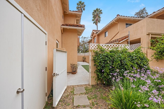 7134 Phelps Rd, Goleta, CA 93117 - view of home's exterior with stucco siding, a tile roof, and a patio