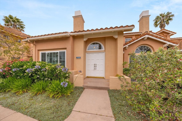 7134 Phelps Rd, Goleta, CA 93117 - doorway to property with a chimney and stucco siding