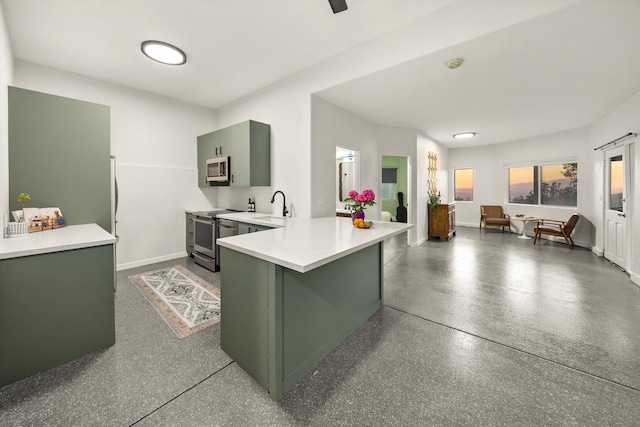 5150 E Camino Cielo, Santa Barbara, CA 93105 - kitchen with green cabinetry, appliances with stainless steel finishes, a sink, light countertops, and a peninsula