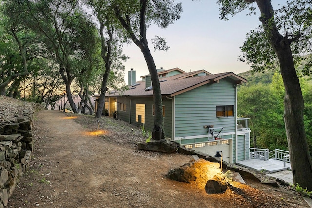5150 E Camino Cielo, Santa Barbara, CA 93105 - view of property exterior with a garage, a shingled roof, and a chimney