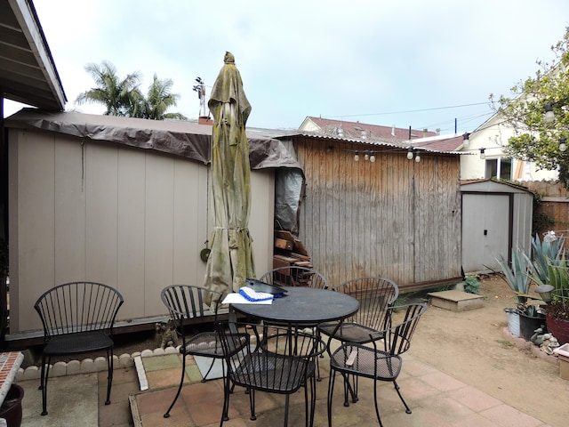 1307 San Andres St, Santa Barbara, CA 93101 - view of patio / terrace with a storage shed and outdoor dining space