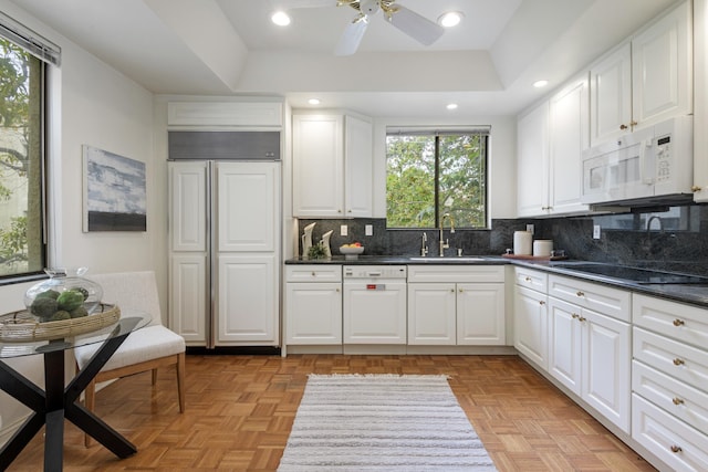 67 Seaview Dr, Montecito, CA 93108 - kitchen featuring white appliances, a sink, dark countertops, decorative backsplash, and white cabinetry