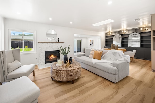 1570 Mountain View Dr, Solvang, CA 93463 - living area with wood finished floors, a tile fireplace, a skylight, and recessed lighting