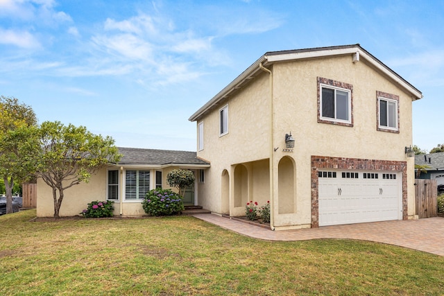 4595 Aragon Dr, Carpinteria, CA 93013 - view of front facade with a garage, stucco siding, and decorative driveway