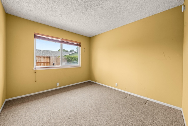 4595 Aragon Dr, Carpinteria, CA 93013 - carpeted spare room with a textured ceiling and baseboards