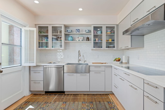 2641 State St Unit 2, Santa Barbara, CA 93105 - kitchen featuring dishwasher, under cabinet range hood, a sink, black electric cooktop, and tasteful backsplash