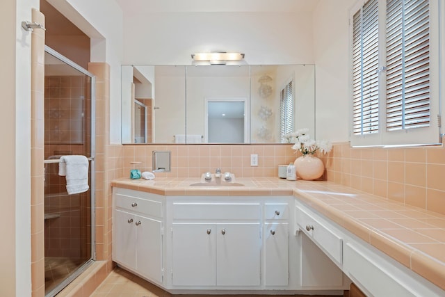 2641 State St Unit 2, Santa Barbara, CA 93105 - bathroom with vanity, a stall shower, and decorative backsplash