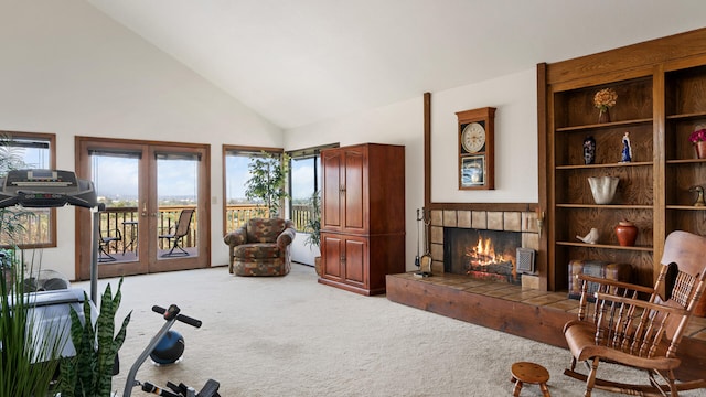 1010 Portesuello Ave, Santa Barbara, CA 93105 - living area featuring light carpet, a tiled fireplace, french doors, and high vaulted ceiling