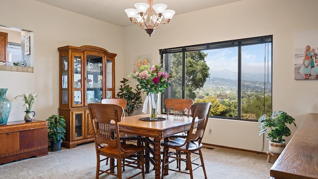 1010 Portesuello Ave, Santa Barbara, CA 93105 - dining area with light colored carpet, a chandelier, a mountain view, and baseboards
