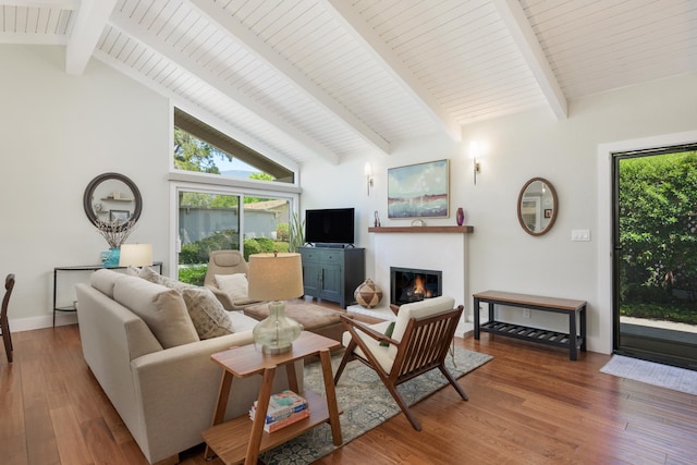 533 N La Cumbre Rd, Santa Barbara, CA 93110 - living area with a warm lit fireplace, wood finished floors, healthy amount of natural light, high vaulted ceiling, and beamed ceiling
