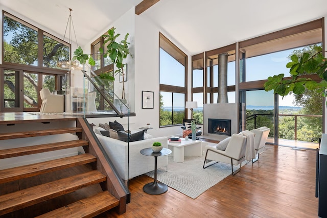 2031 Cielito Ln, Santa Barbara, CA 93105 - living area with wood finished floors, a warm lit fireplace, and a high ceiling