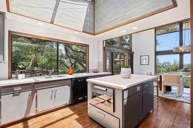 2031 Cielito Ln, Santa Barbara, CA 93105 - kitchen with black dishwasher, light countertops, wood-type flooring, a kitchen island, and recessed lighting