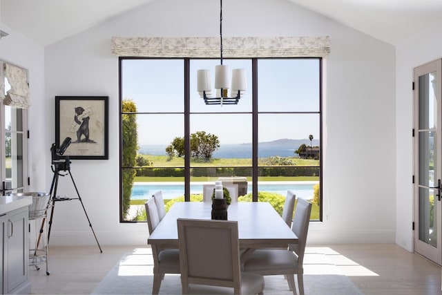 2720 Montecito Ranch Pl, Summerland, CA 93067 - dining room with vaulted ceiling, light wood-style flooring, a chandelier, plenty of natural light, and baseboards