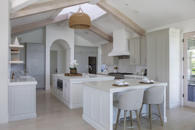 2720 Montecito Ranch Pl, Summerland, CA 93067 - kitchen with an island with sink, a sink, custom range hood, a kitchen breakfast bar, and recessed lighting