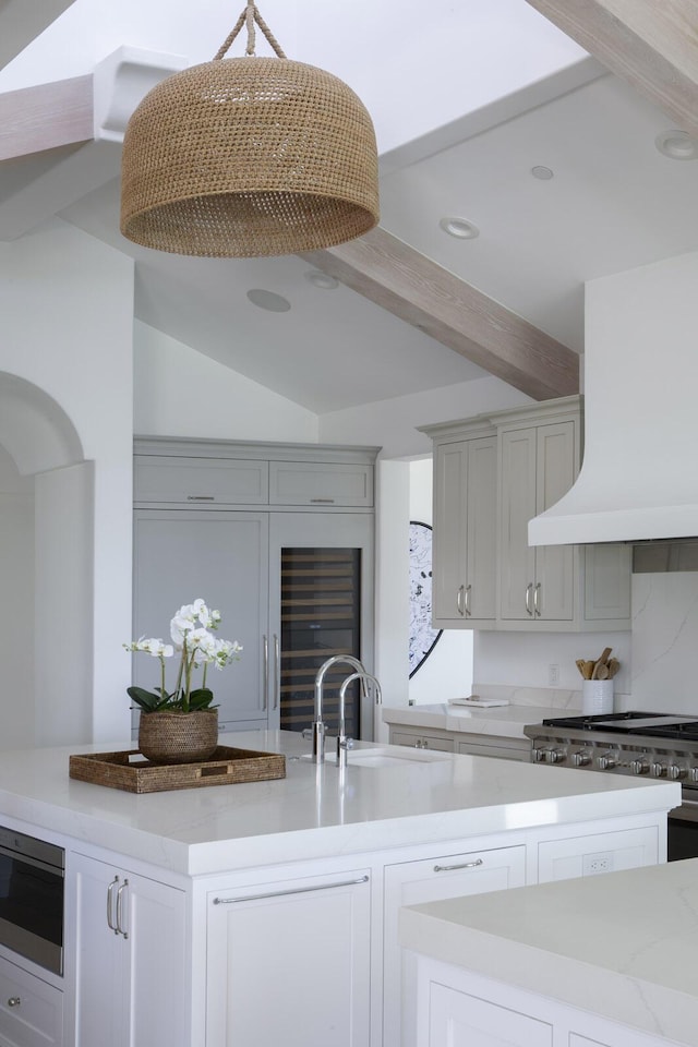 2720 Montecito Ranch Pl, Summerland, CA 93067 - kitchen featuring custom range hood, light stone counters, a sink, recessed lighting, and white cabinets