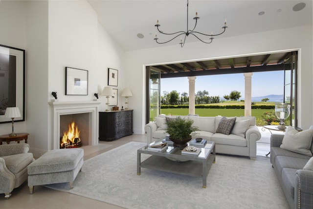 2720 Montecito Ranch Pl, Summerland, CA 93067 - living area with a chandelier, a lit fireplace, vaulted ceiling, and baseboards