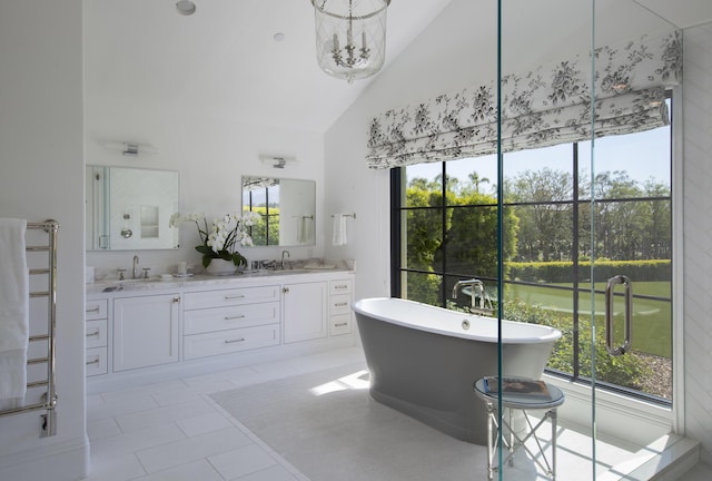 2720 Montecito Ranch Pl, Summerland, CA 93067 - bathroom featuring double vanity, high vaulted ceiling, a freestanding bath, and tile patterned flooring
