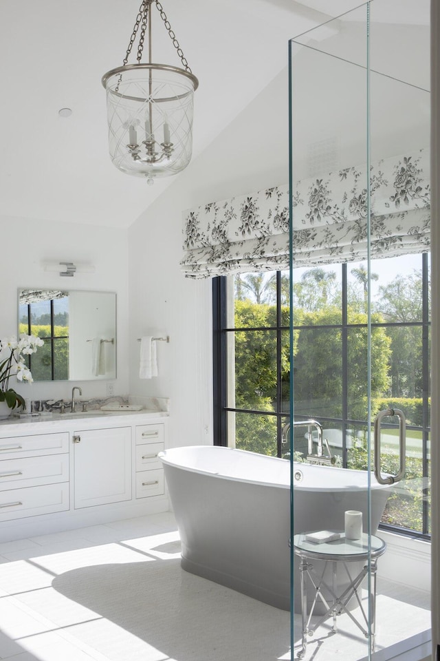 2720 Montecito Ranch Pl, Summerland, CA 93067 - full bath featuring vanity, vaulted ceiling, a freestanding bath, and tile patterned floors