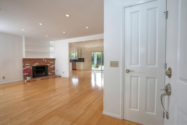 6231 Covington Way, Goleta, CA 93117 - living area with light wood-type flooring, recessed lighting, a fireplace, and baseboards