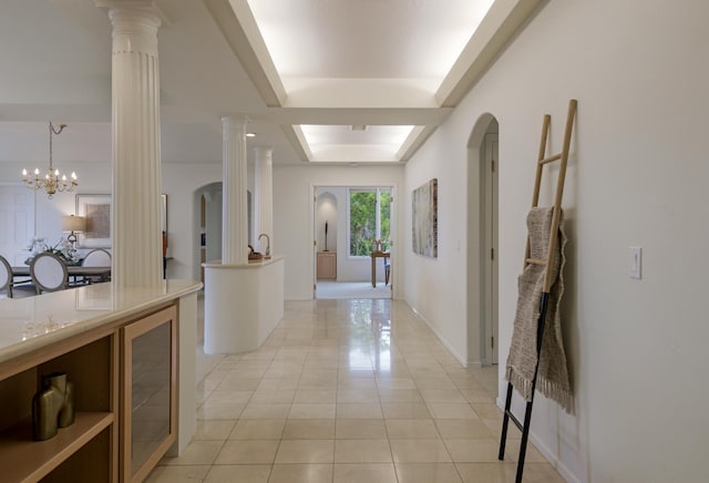 4477 S Shadow Hills Blvd Unit E, Santa Barbara, CA 93105 - hallway with light tile patterned flooring, decorative columns, arched walkways, a chandelier, and baseboards