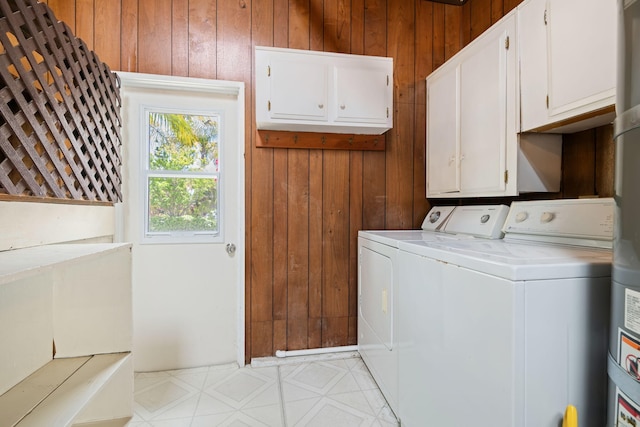 7659 Dartmoor Ave, Goleta, CA 93117 - laundry area with wooden walls, washing machine and dryer, and cabinet space