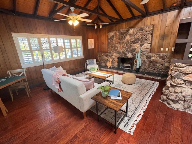 7659 Dartmoor Ave, Goleta, CA 93117 - living area featuring wooden walls, a ceiling fan, a stone fireplace, hardwood / wood-style flooring, and wood ceiling